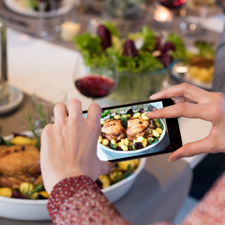 woman taking photo of food